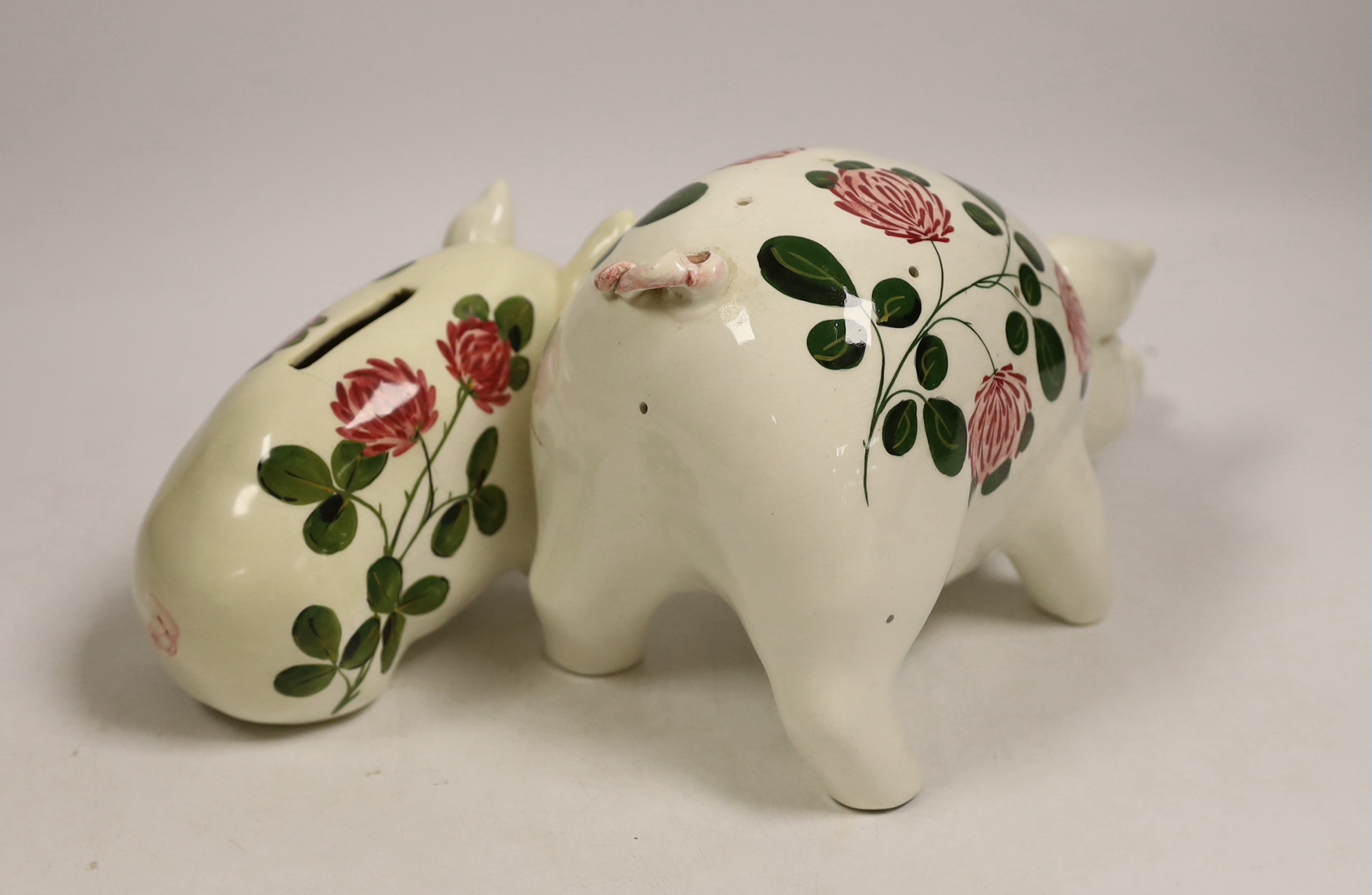 A Plichta rose decorated pig money box, 16cm, and a Plichta rose decorated hatpin holder pig, 23cm and two other Plichta pigs